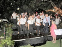 Christmas Carols in the rain at a packed Government House on Monday evening