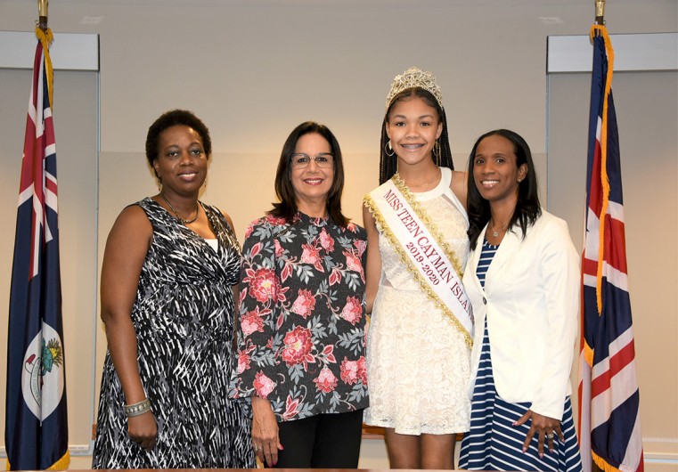 (Left to Right) Scholarship Administrator Dr Nicole Thompson, Councillor Barbara Conolly, Miss Teen Cayman Ashley Gooden and Chairperson of Miss Teen Cayman Islands Elesha Graham, take a photograph together at the end of the handover ceremony
