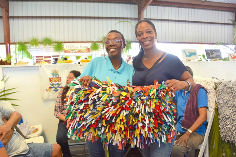 (From left to right) SRC Client Tessa Terry poses proudly with a traditional rag rug alongside, Doona Wilson, Vocational Officer at SRC