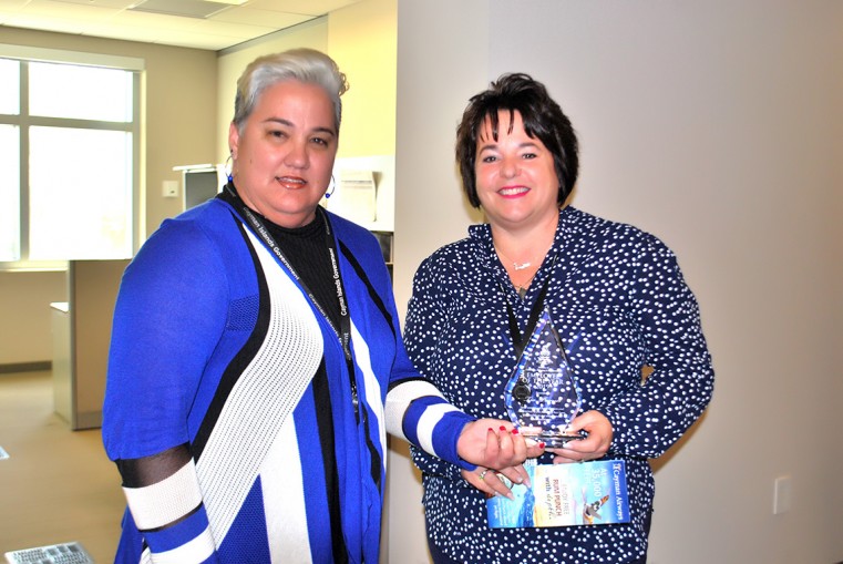 (Left to right) Deputy Chief Officer in the Ministry of Commerce, Planning and Infrastructure, Ms. Tamara Ebanks presents the Ministry’s 2019 Employee of the Year to Ms. Tia Parrott