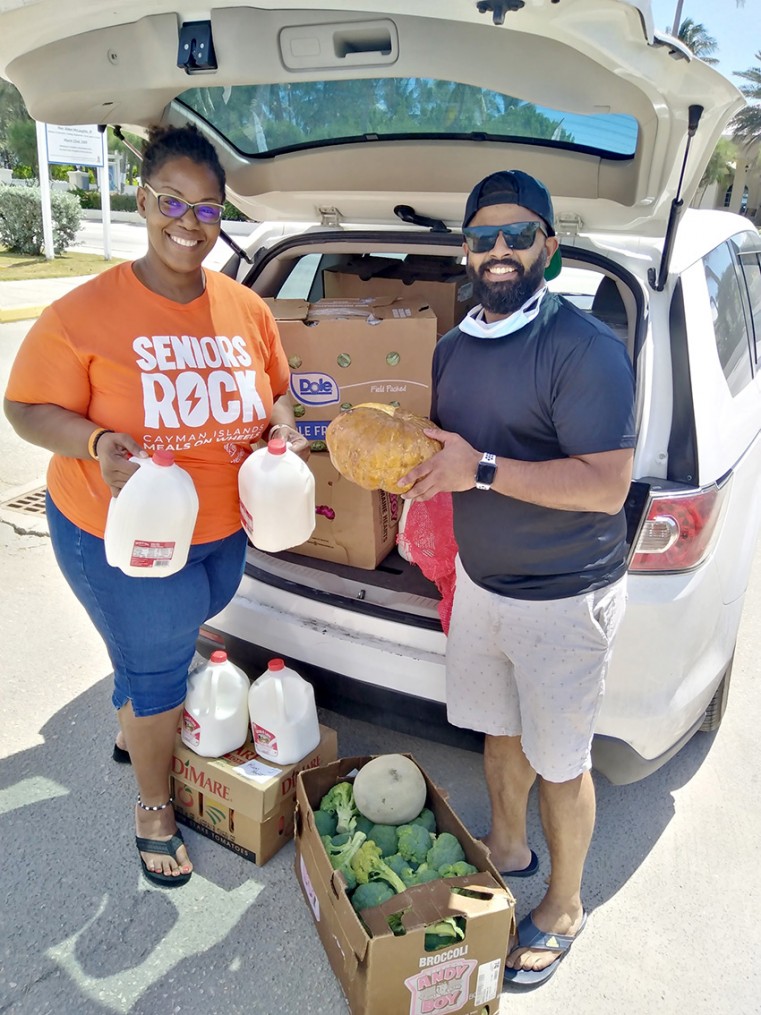 Jennifer West, General Manager for MOW receives a car full of supplies, donated by Rum Point Restaurant