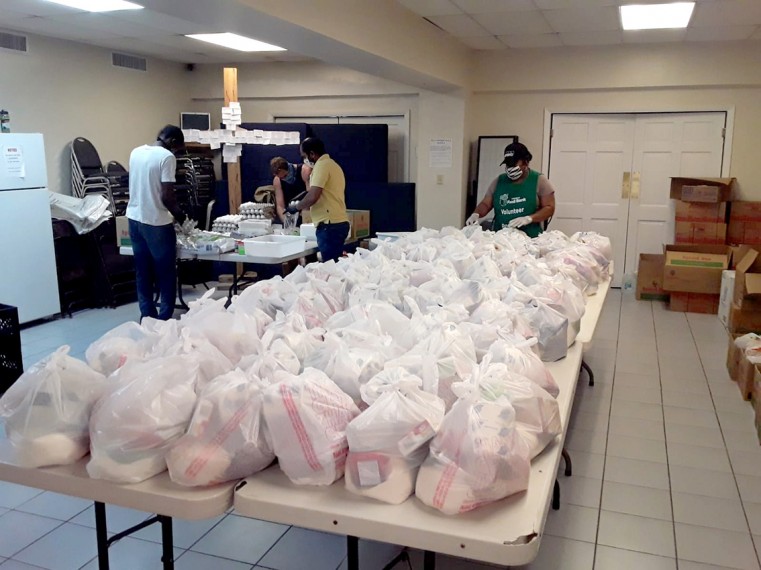 Cayman Food Bank volunteers prepare packages for delivery. The organisation provides support to residents in all districts