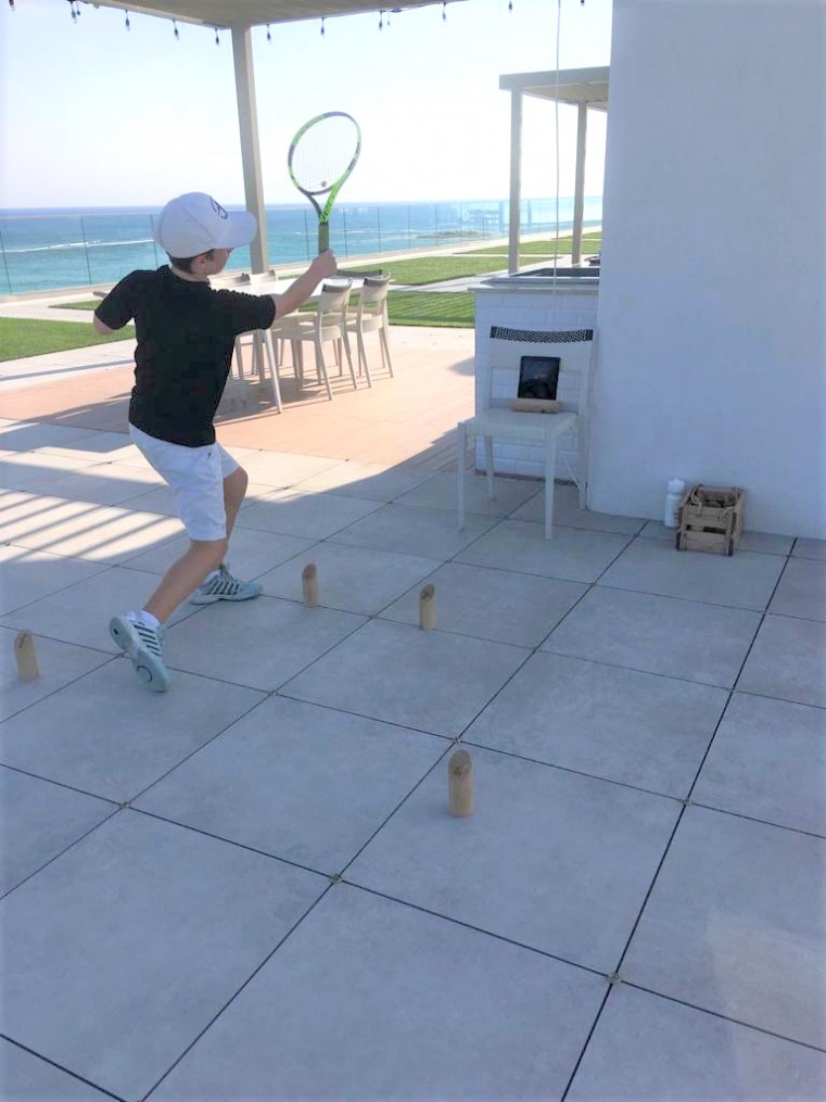 Junior CI Tennis Club member George Zimmerman practices via Zoom