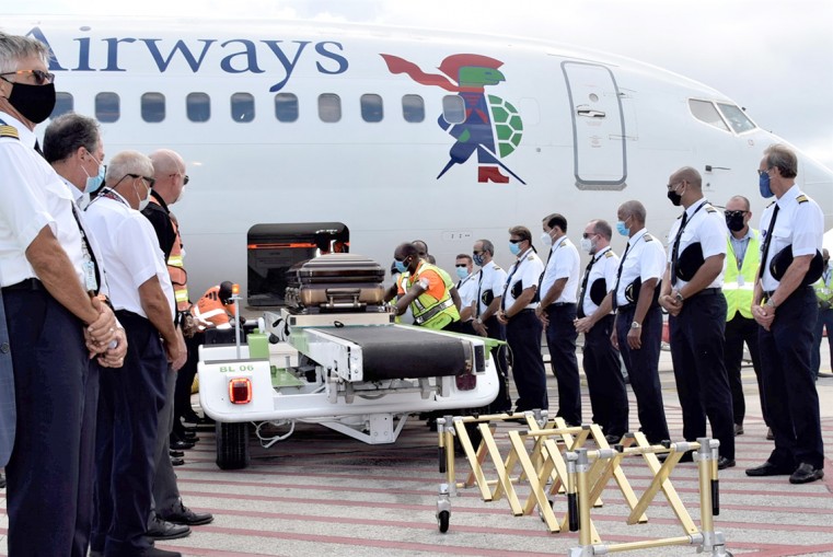Pilots, and other people who knew Captain Robert Hamaty, pay their respects as the casket emerges from the aircraft