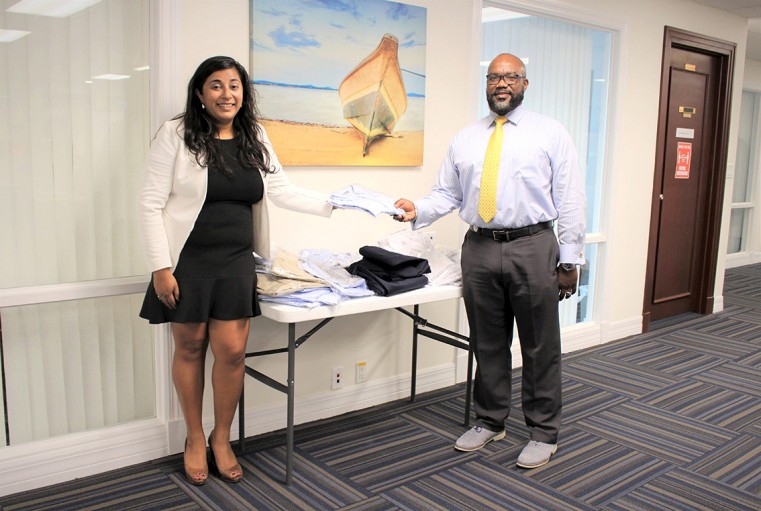 Rayle Roberts, Deputy Director of Department of Children and Family Services receiving donation from Mahreen Nabi, from Acorn Media, and BPW program volunteer
