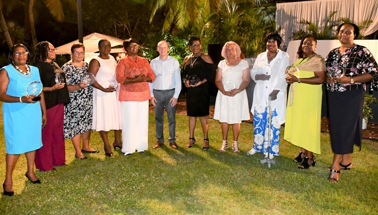 Long Service awardees with plaques presented by the Governor, Mr. Martyn Roper at the DCFS Recognition Awards Dinner on Saturday, 26 September