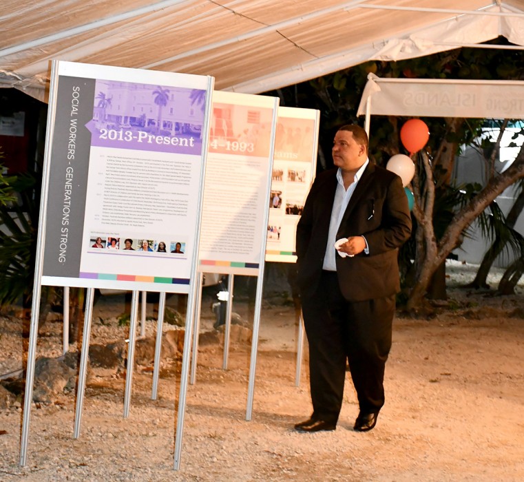 Councillor for Community Affairs Mr. Austin Harris looks at the Social Work Month exhibition during the DCFS Recognition Awards Dinner on Saturday, 26 September