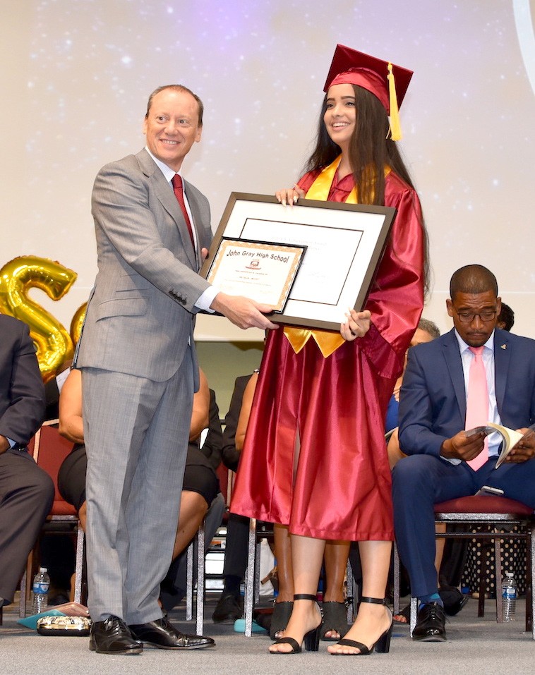 His Excellency, Governor Martyn Roper presents the Government Achievement Award for the Most Improved Academic student to Janice Contreras-Holness