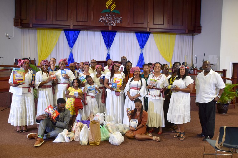 Artistes who performed at the benefit concert gather at the end of last month’s benefit concert with some of the food items donated at the event