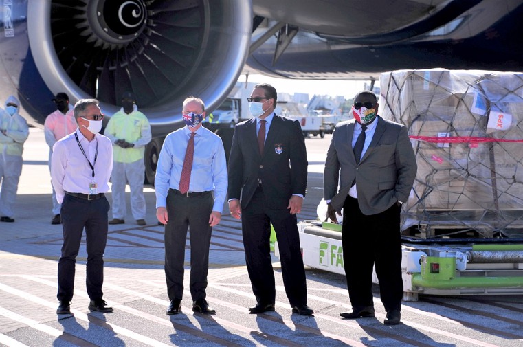 (L-R) Dr. John Lee, H.E the Governor, Martyn Roper, Premier, Hon Alden McLaughlin, and Minister of Health Hon. Dwayne Seymour greet the arrival of the covid vaccines
