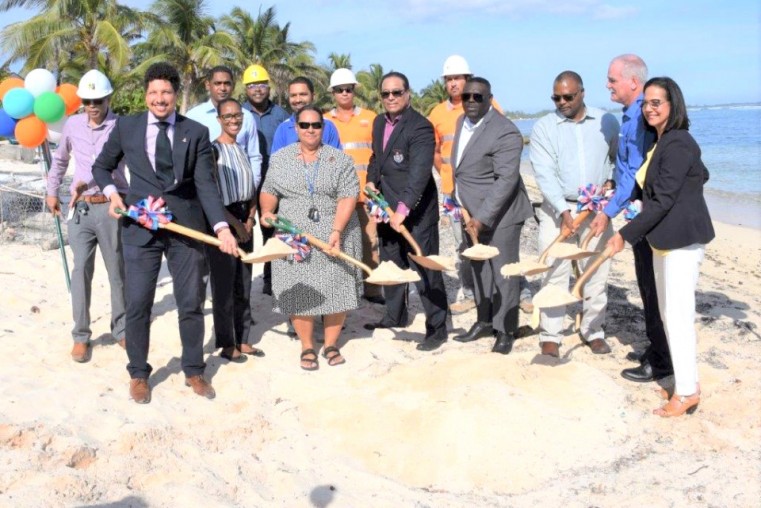 Several civil servants look on as (from left) Hon. Juliana O’Connor-Connolly, Premier Hon. Alden McLaughlin, Hon. Dwayne Seymour, Mr. Alva Suckoo, Mr. David Wight and Hon Barbara Conolly, break ground for the new dock at Coe Wood Beach