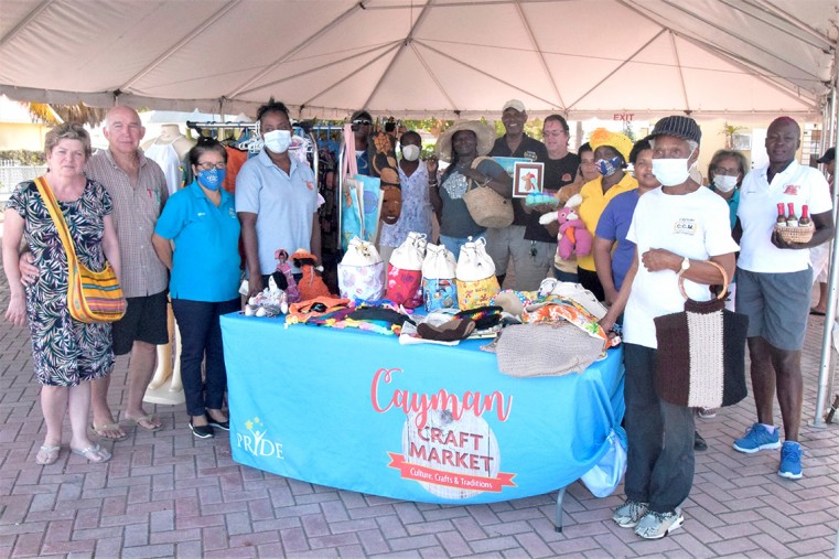 The craft market reopens. Photo shows all the vendors, as well as two of the first visitors (left of photo)
