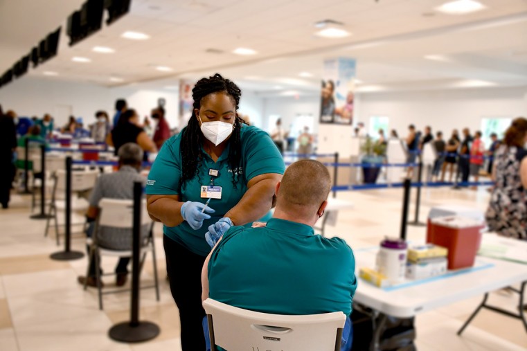 HSA Registered Nurse, Allicia Gaynor, administers the COVID vaccine at the Offsite Owen Roberts International Airport (ORIA)