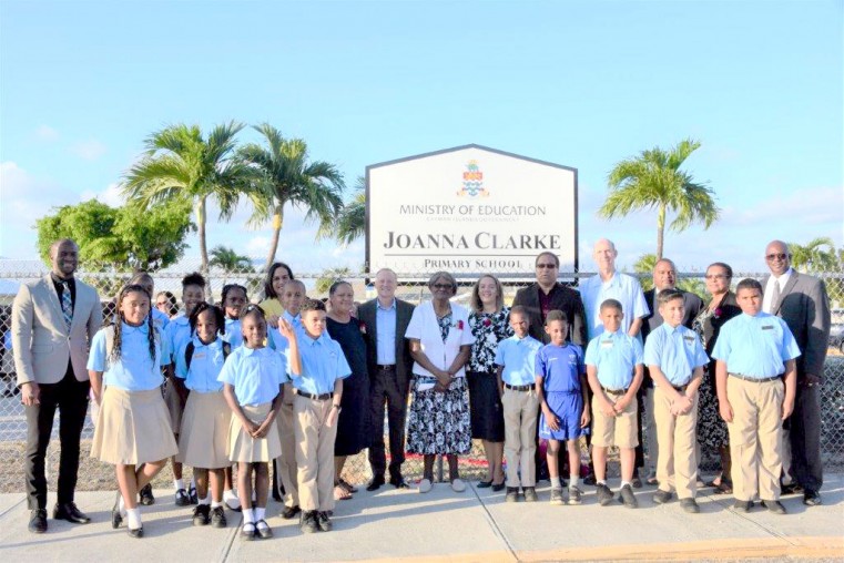 His Excellency Governor Martyn Roper, Hon. Alden McLaughlin, Hon. Juliana O’Connor-Connolly, Ms. Barbara Conolly, Mr. Anthony Eden, Mr. Delton Pedley and several others join Ms. Judith Witter and Theo