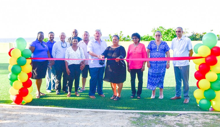 Minister of EYSAL Hon. Juliana O'Connor-Connolly and Deputy Premier Hon. Moses Kirkconnell cut the ceremonial ribbon to officially open the new playing fields at Creek and Spot Bay Primary Schools while representatives from the CSBPS, Ministry of EYSAL, a