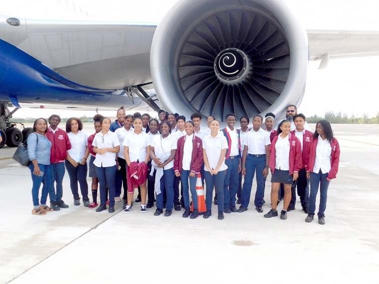 John Gray High School Students outside on the runway taking a close look of the British Airways B777