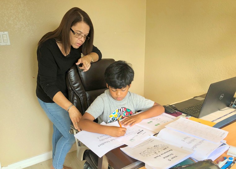 SEN Case Manager Inclusion, Ms. Deidre Carmola assists her son Sammy J. Carmola with his schoolwork during the 2020 Shelter-in-place arrangement