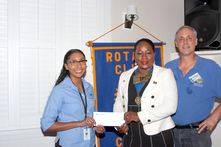 Mrs Edlyn Ruiz Stoll (left), Corporate Communications Officer of the Water Authority, hands donation to President Stacy Parke (middle) and Director Hendrik van Genderen (right) of Rotary Sunrise