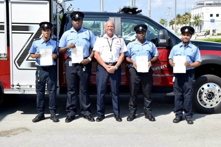 Chief Fire Officer, Paul Walker (third from left) presents (left to right) Christopher Solomon, Angel Lopez-Hawkins, Robert Michael Harris III, Ethan Hydes, and David Conolly with their Level 2 Certif