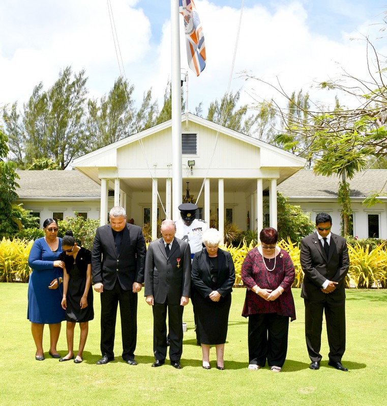 Seen standing with heads bowed as a mark of respect while the guns boomed are (l-r) Ms Gina Terry, Ms Gabriella Terry, Deputy Governor Hon. Franz Manderson, the Governor, Mrs. Lissie Roper, Ms Katherine Jackson and Mr. Daniel Lee