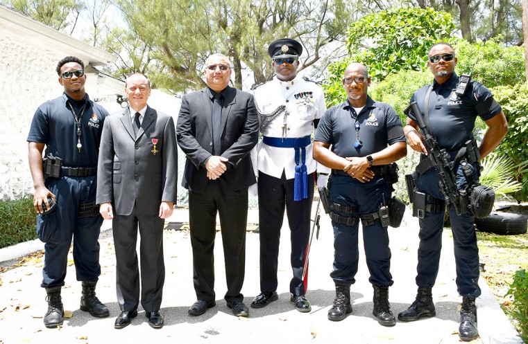Prior to the 21-gun salute, His Excellency the Governor, Mr. Martyn Roper, and the Deputy Governor Hon. Franz Manderson met with the RCIPS team in charge of the gun salute. (L-r) PC Matthew Greaves, the Governor, the Deputy Governor, the Governor’s Aide-d
