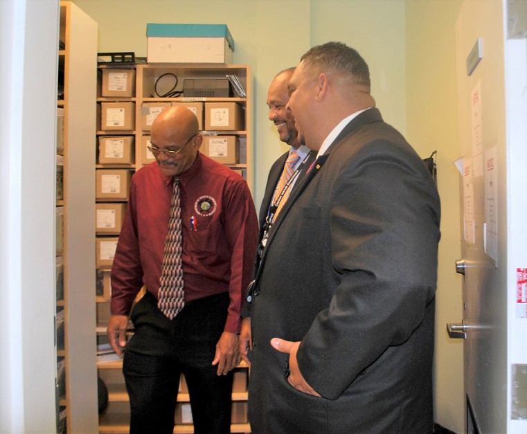 Director of DVDL, David Dixon shows Hon. Jay Ebanks and PS Isaac Rankine around the Crewe Road office