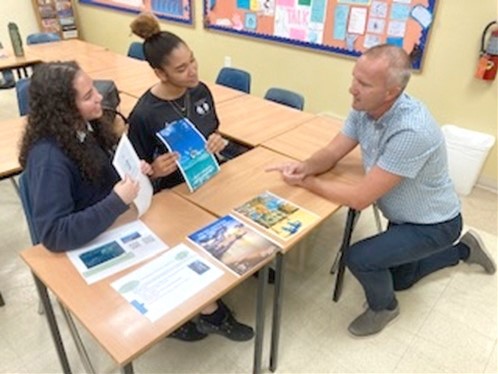 Hannah and her classmate Aliyah Reid – going through their own Cayman Islands marketing campaign “enjoy freedom the Cayman way’ with Mr Baker