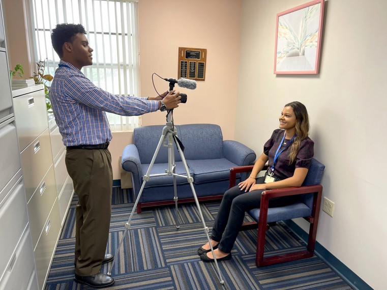 Marketing and Communications Intern Dayger Martinez-Taylor recording Corporate Services Intern Halle Miller for a promotional video