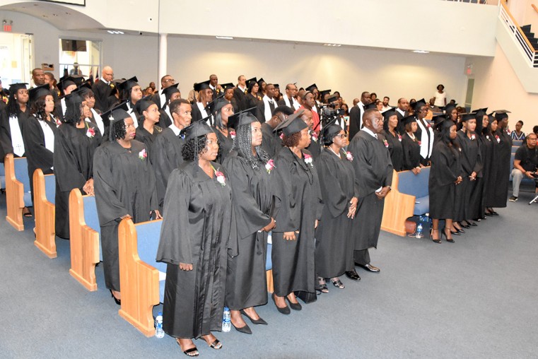 All the graduates stood as their degrees were conferred upon them