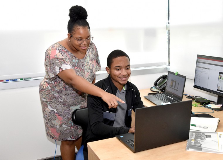 Summer Intern Le’ Bron McLean (seated) and CUC’s Japhia Augustine, Marketing Specialist