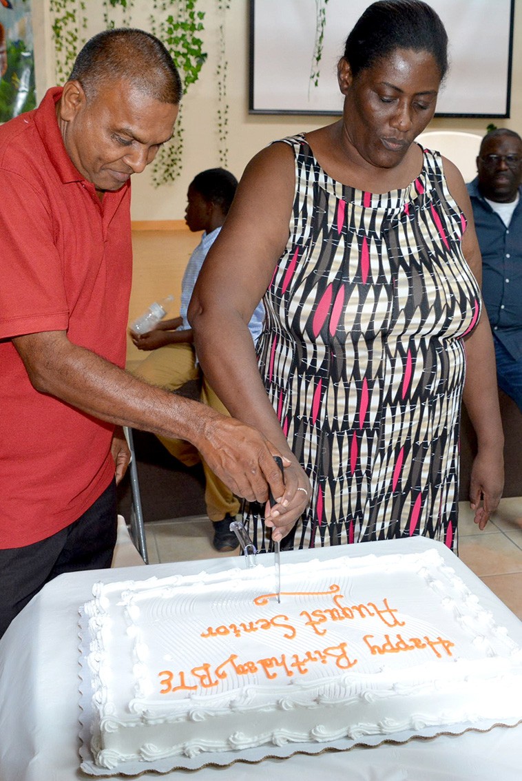 Clifford Chotan and Sandra Wellington cut the Happy Birthday cake for everyone to share