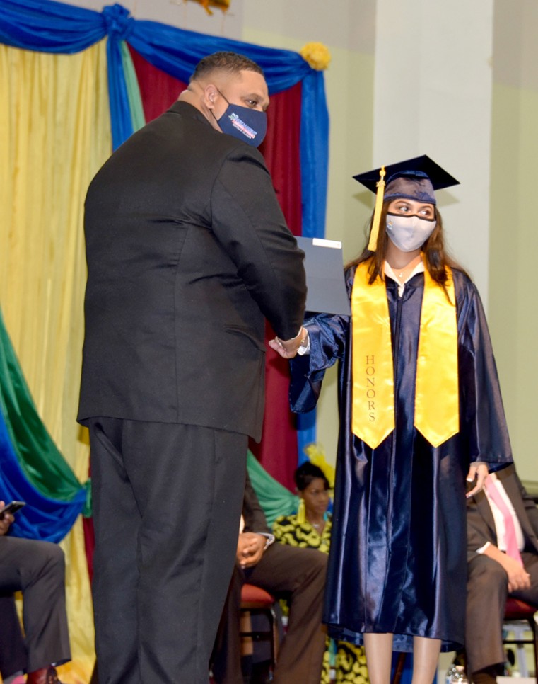 Hon. Johany ‘Jay’ Ebanks presents Diane Brown with her diploma