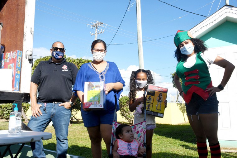Division Manager Randy Rankin with one of the families at the Christmas Toy Donation in Washington Blvd.