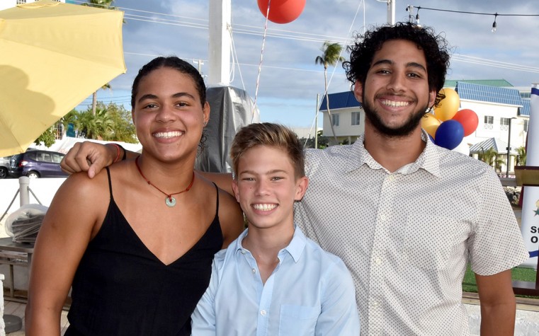 2 Swimming Team Co-Captains Kyra Rabess (17)  and Corey Frederick-Westerborg (18) encourage the younger swimmers, such as 13-year old Jack Clark-Terrell who went to CARIFTA for the first time