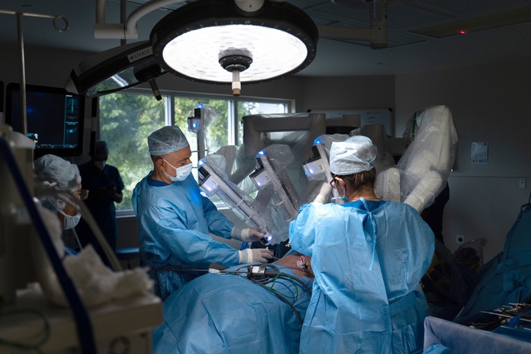 Dr Stone prepares a patient for a robotic surgical procedure with the assistance of Dr Pooja
