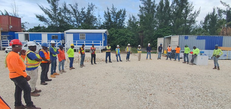 Workers gather on site for the morning briefing at an Arch an Godfrey project.