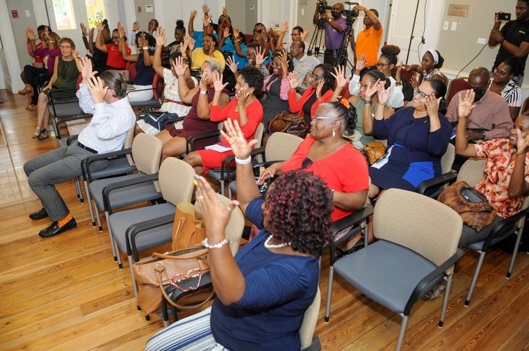Members of the Deaf Awareness Workshop “Hi There! I Can’t Hear” applaud the speakers.