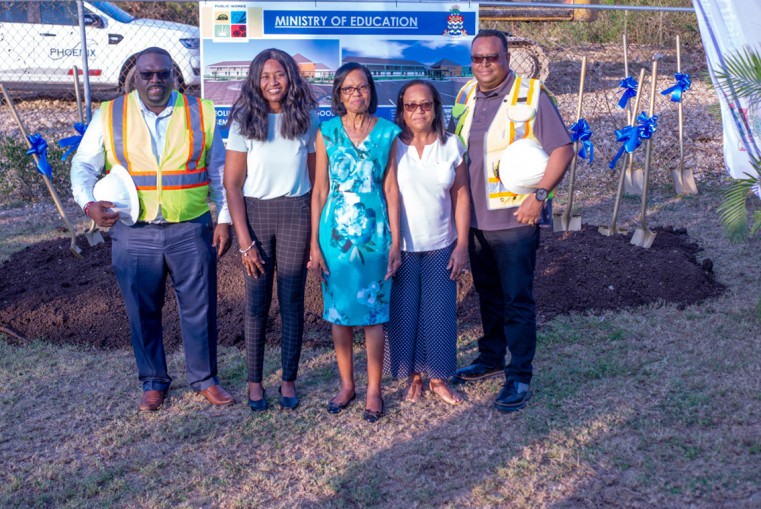 Hon. Dwayne Seymour (l) and Deputy Premier, Hon. Chris Saunders (r) are photographed with retired educator, Mrs. Francine Gardener (c) and her sisters after Mr. Seymour’s announcement that the new hal