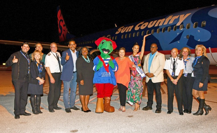 Cayman Islands Government officials, and Sir Turtle greet the Captain and crew of the inaugural Sun Country flight