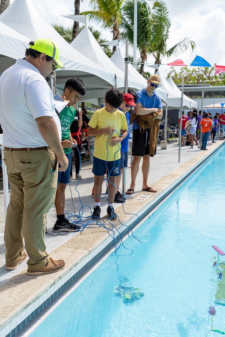 Teams navigate the underwater courses with remote operated vehicles at the Camana Bay pool