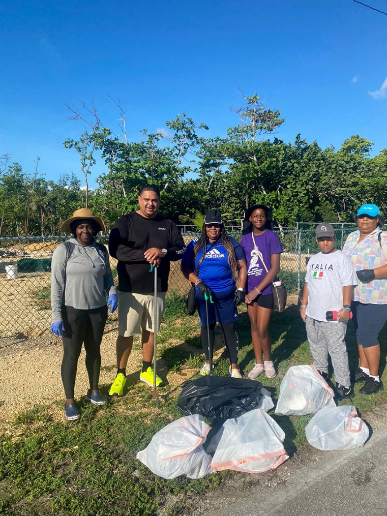 Minister Jay Ebanks and North Side BTF Team show off trash collected along Frank Sound Road