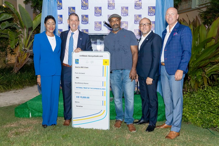 National Trust for the Cayman Islands (NTCI), Historic Programmes Manager Stuart Wilson accepts a check on behalf of the NTCI’s environmental conservation and preservation programme.