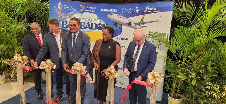 Tourism Minister, the Honourable Kenneth Bryan, along with members of the Cayman Airways team and dignitaries from the Barbados contingent cut the ribbon to launch the inaugural flight from Grand Caym