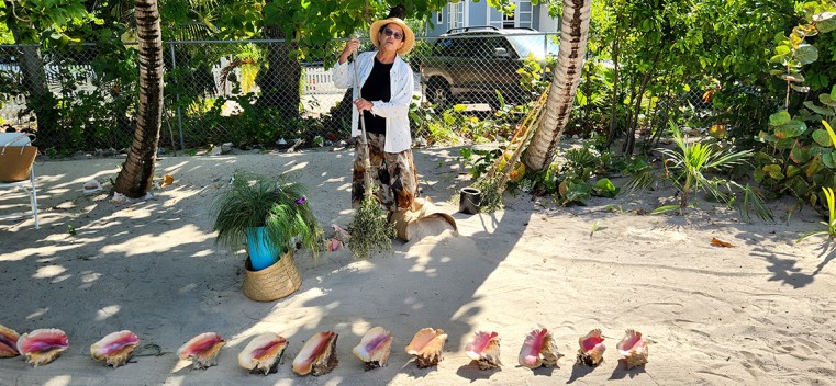 Mrs. Lorna Bush sweeps the sand in preparation for Christmas at the CNCF Christmas of Yesteryear event held at Miss Lassie’s House on 8th and 9th of December, 2023. (Photo: Stuart Wilson)