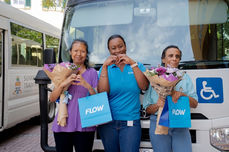 From left: Sunrise Adult Training Centre Recipients Elena Ow-lam (left) and Paula Bitsy (right) along with Krystle Hinds, Brand Manager at Flow (middle)