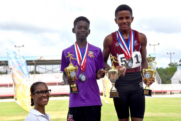 (l-r) MoE Acting Chief Officer, Ms. Lyneth Monteith, Victor Lodorum John Gray High School’s Jaysean Seymour (U-15) and Donald Mitchell.