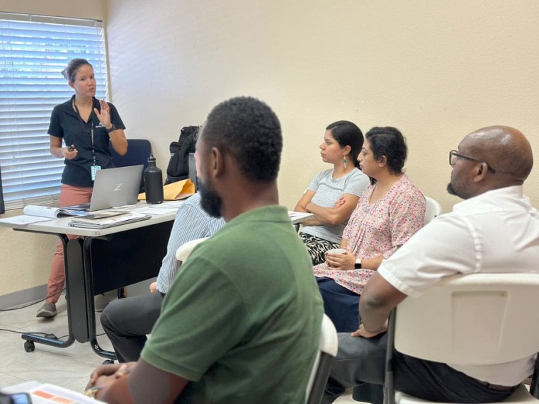 MoE Designated Child Safeguarding Lead, Camila Muniz Ferriera (standing) conducts training session with persons from Calvary Baptist Christian Academ
