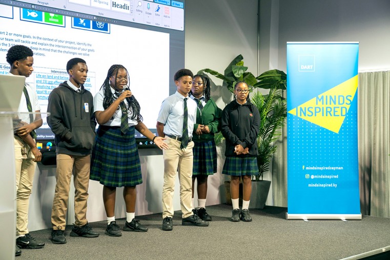 Cayman Academy students present their pitch on using recycled plastic to build roads.
