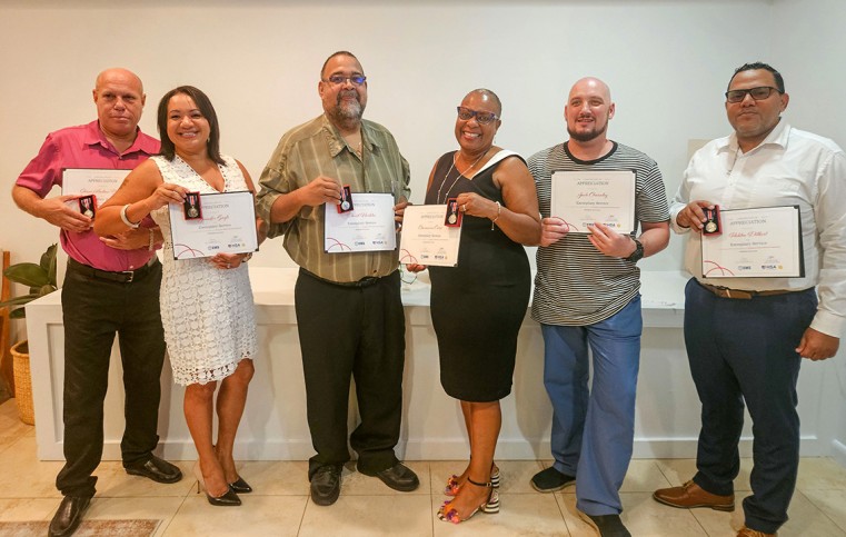 Members of the Sister Islands EMS Team – Shane Brown, Jennifer Gayle, David Hurlston, Charmaine Coore, Jack Charnley, and Ralston Dilbert, display their Coronation Medals and Certificates of Appreciat