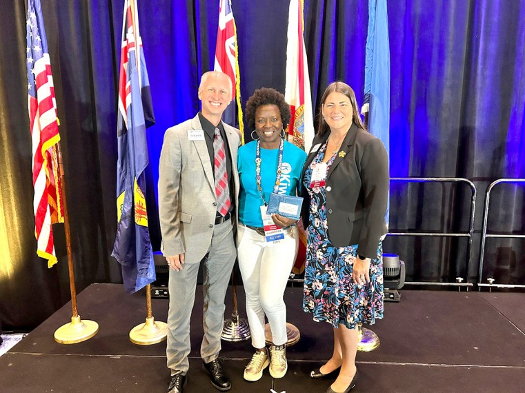 Lieutenant Governor Winsome Radcliffe (center) is honored with the Distinguished Lt. Governor Award alongside Florida District Governor Prairy Riehl (right) and Florida District Governor Elect Jeremy